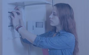 Woman checking circuit breaker